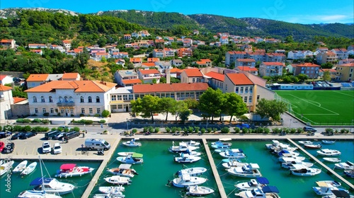 Rab - Croatia - An aerial view with the drone over the beautiful town of Rab - The drone rises above the town of Rab and the marina and opens up a fantastic view of the Croatian islands