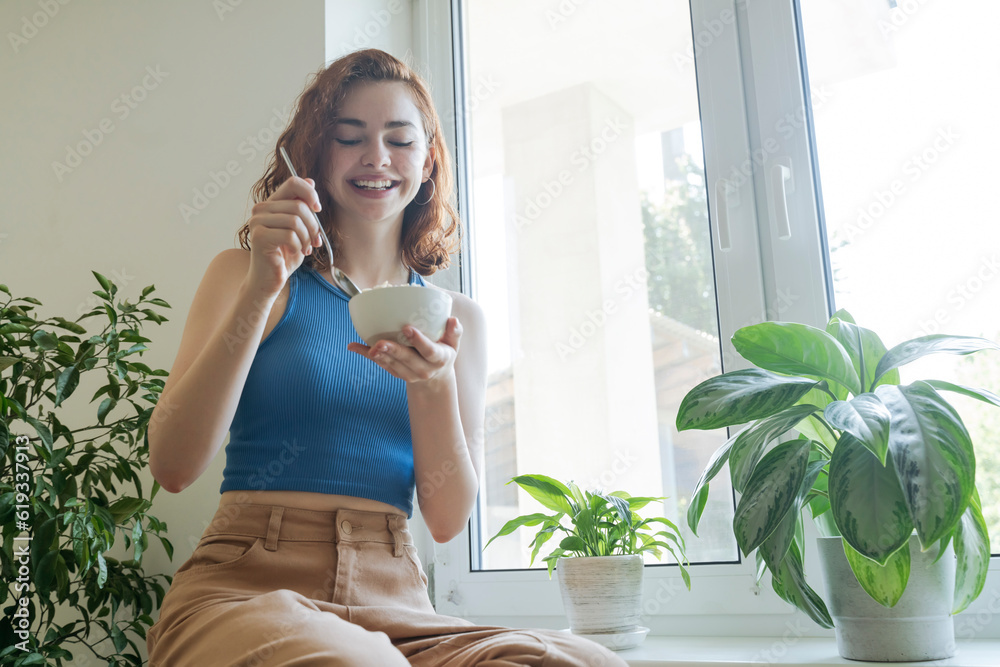 Happy young woman having breakfast at home Happy young woman having breakfast at home