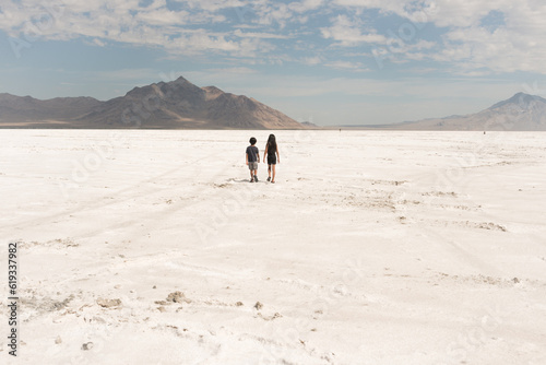 boy and girl wlaking on salt flats of Utah at Bonneville photo