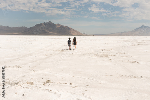 boy and girl wlaking on salt flats of Utah at Bonneville
