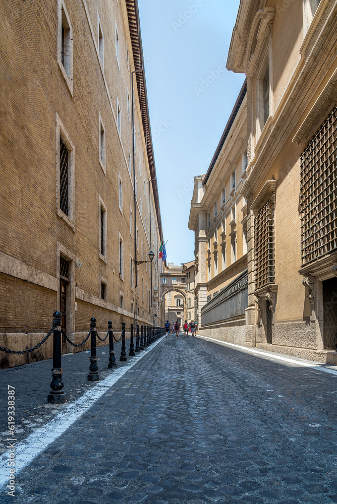 Narrow italian street with a corridor between buildings