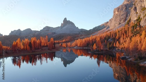 4k drone forward video (Ultra High Definition) of popular tourist destination - Federa lake among red larch trees. Impressive sunrise in Dolomite Alps. Gorgeous morning scene of Italy, Europe.