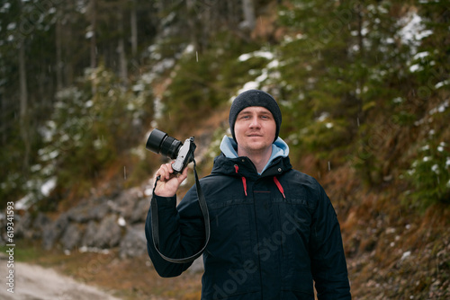 A Male Photographer Immersed in the Stunning Alpine Mountains. The photographer outdoors.