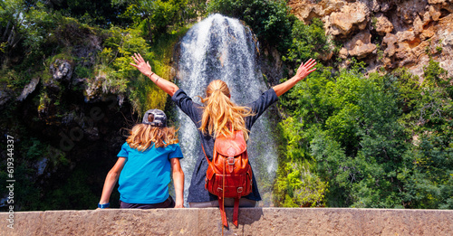 family enjoying at beautiful waterfall- France, Salles la Source, Aveyron photo