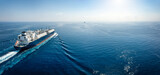 A big LNG tanker ship travelling over the calm, blue ocean as a concept for international fuel industry with copy space