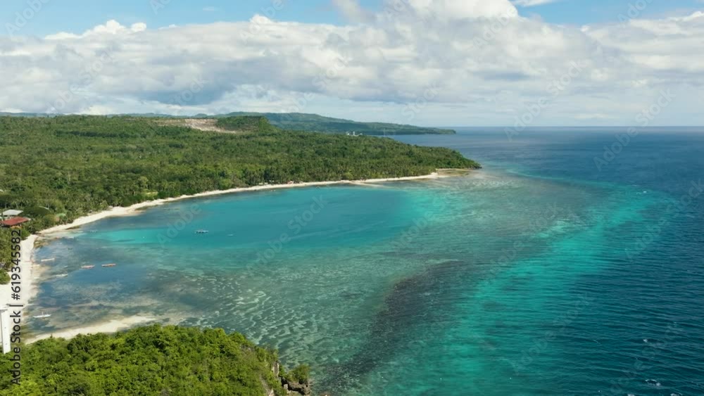 Seascape with tropical island and a sandy beach in the sea. Siquijor, Philippines. Seascape with tropical island and a sandy beach in the sea. Siquijor, Philippines.
