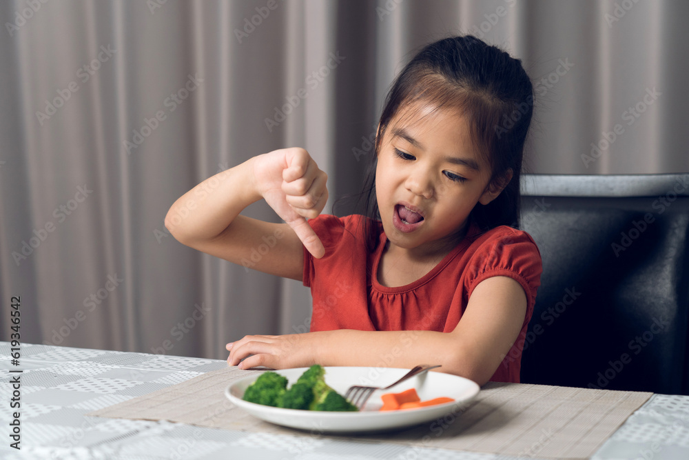 Little cute kid girl refusing to eat healthy vegetables. Children do not like to eat vegetables. Little cute kid girl refusing to eat healthy vegetables. Children do not like to eat vegetables.