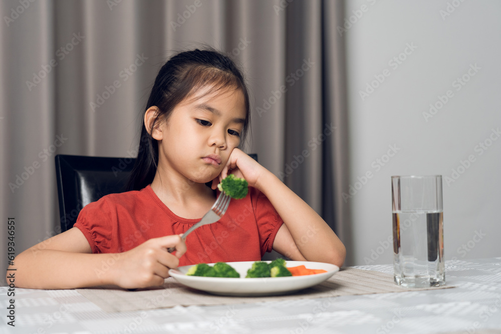 Little cute kid girl refusing to eat healthy vegetables. Children do not like to eat vegetables. Little cute kid girl refusing to eat healthy vegetables. Children do not like to eat vegetables.