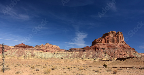 colorful red rock formations  and assembly hall peak  on a sunny winter day  along the buckhorn draw scenic backway in the northern san rafael swell near green river,  utah  photo