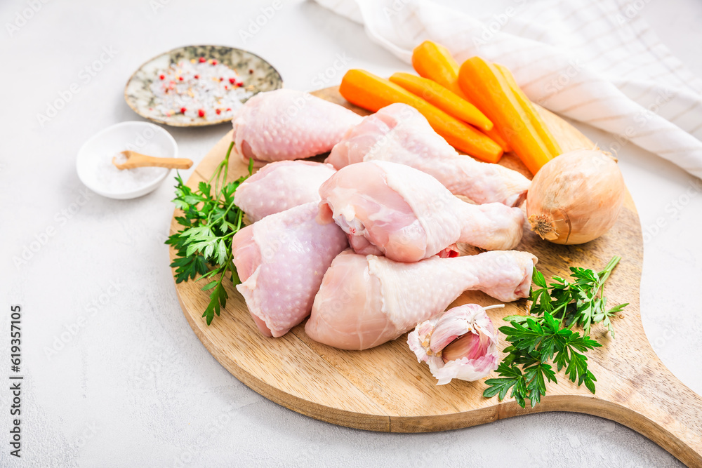 Raw chicken drumsticks with vegetables ans spices prepared for cooking Raw chicken drumsticks with vegetables ans spices prepared for cooking