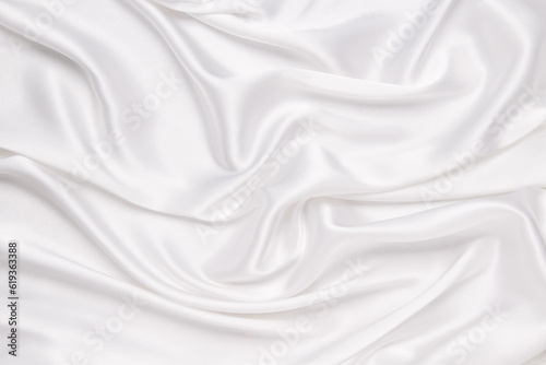 Abstract white fabric texture background. Cloth soft wave. Creases of satin, silk, and cotton.