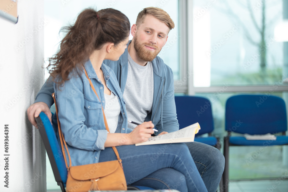 couple doing crosswork while in waiting room couple doing crosswork while in waiting room