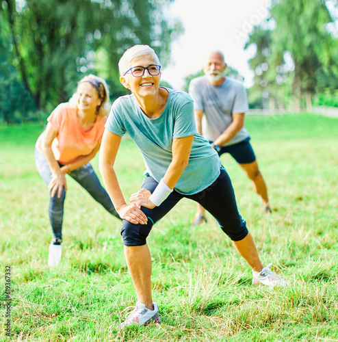 Fototapeta Naklejka Na Ścianę i Meble -  outdoor senior fitness woman man lifestyle active sport exercise healthy fit retirement stretching elderly couple training class clothing