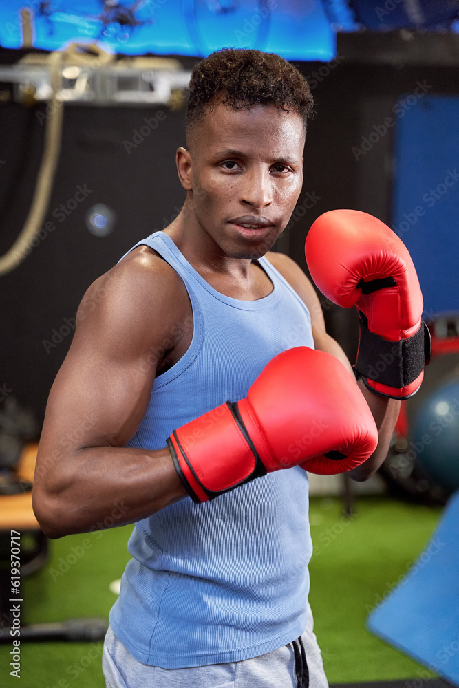  Self-confident black boxer in a defensive stance with gloves, ready to face any opponent on the Rhine.
