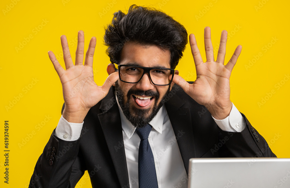 Indian businessman use laptop computer, making funny face, fooling ...