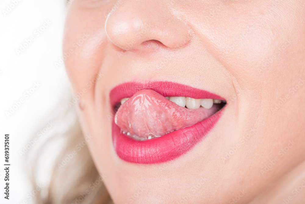 Naklejka premium Woman Face with Open Mouth And Tongue Out. Bright Red Lipstick in Use and White Teeth. Try To Touch Nose.