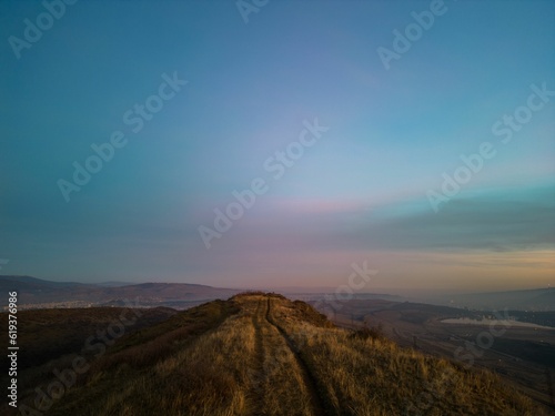 Majestic mountain landscape with colorful sunset sky on the horizon