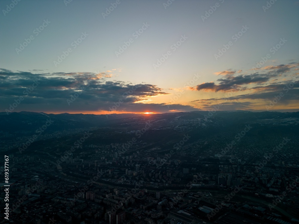 Aerial view of the cityscape at sunset with a cloudy sky in the background perfect for wallpapers