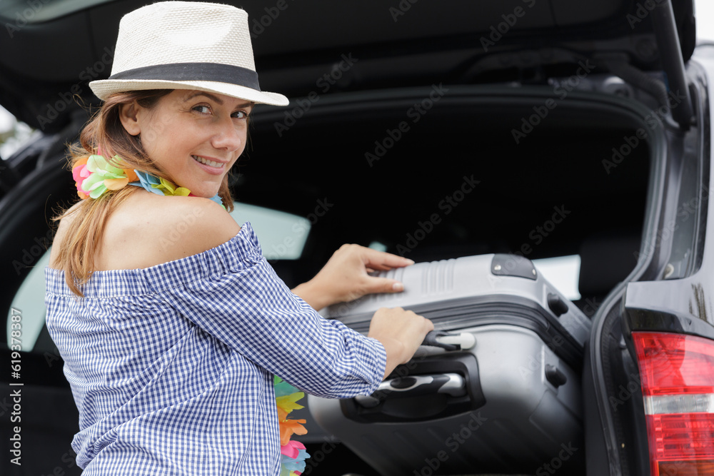 woman travelling by car with suitcases and luggage