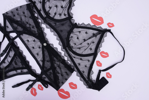 Lace sexy black women's underwear, with red kisses on a light background.