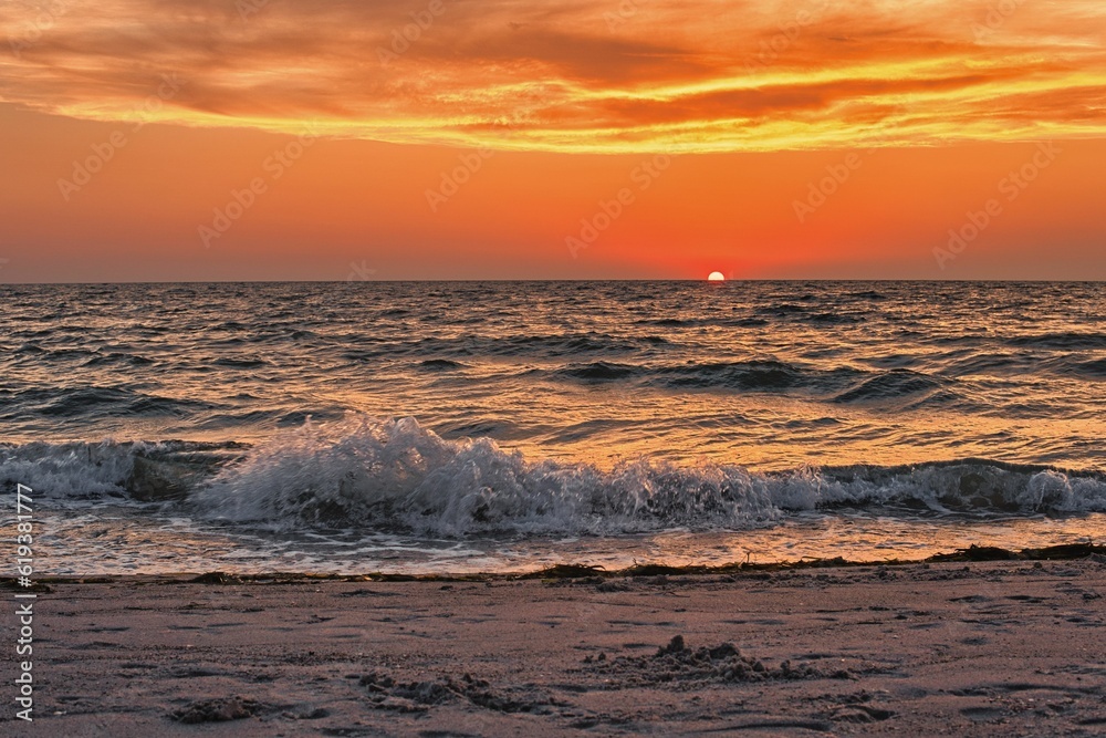 Sunset over the ocean from the beach, with turbulent waves crashing against the shore, Gulf of Mexico, Captiva Island