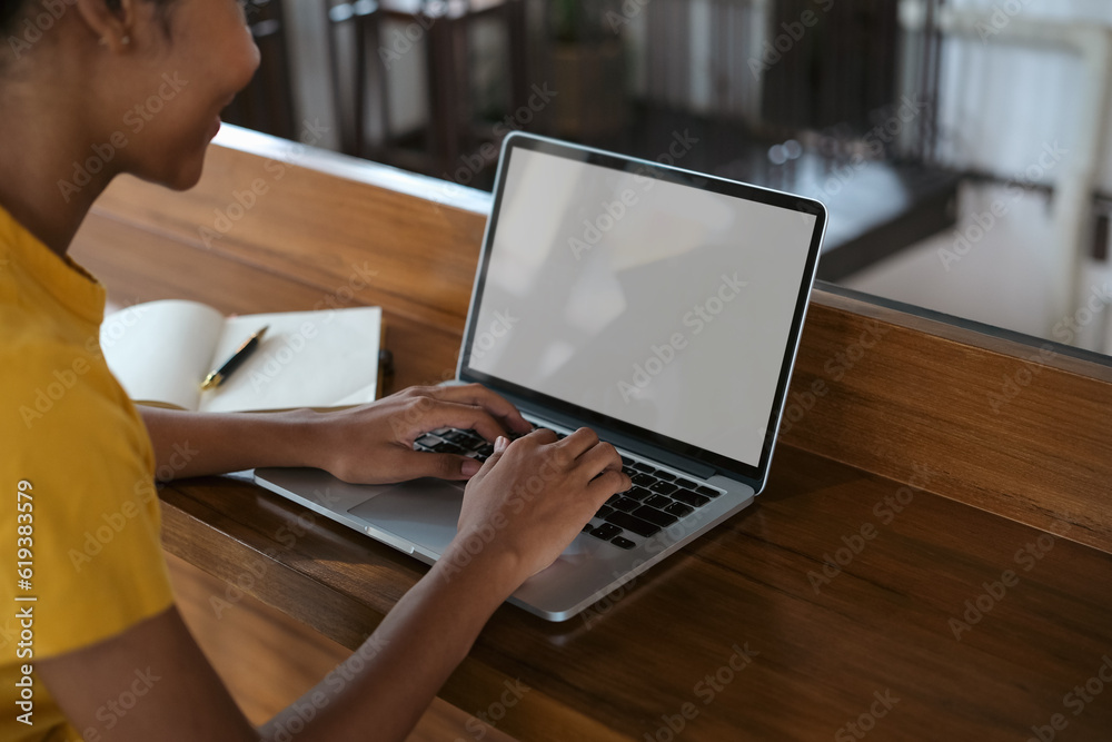 Side view of university student woman typing on laptop, doing homework, working on research project online Side view of university student woman typing on laptop, doing homework, working on research project online