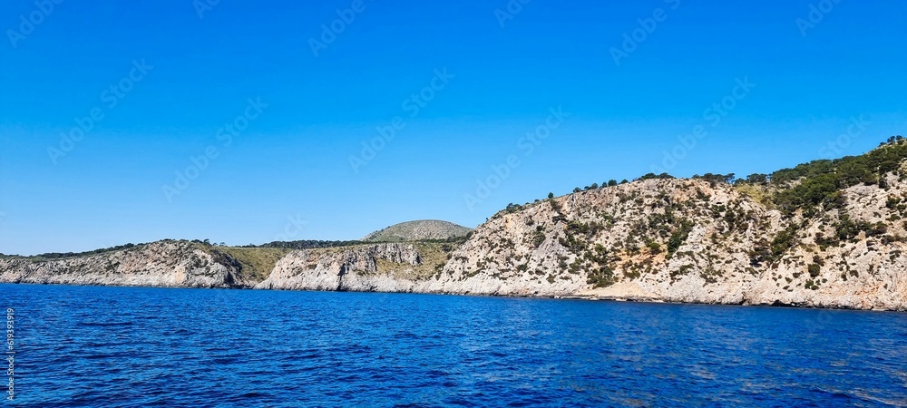 Scenic panoramic view of the blue sea and rocky shoreline. Alcudia, Balearic Islands.
