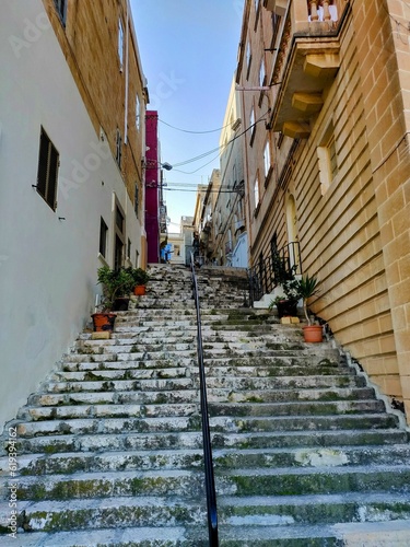Old stone stairway surrounded by residential buildings. Malta.