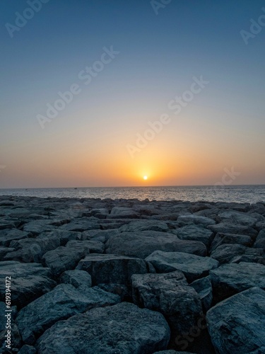 Breathtaking scenery of a sunset over the rocky beach - great for wallpapers