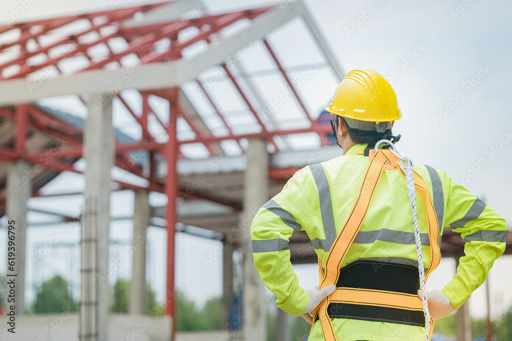 Engineers stand to inspect the construction of a house that is still being built. Engineers stand to inspect the construction of a house that is still being built.