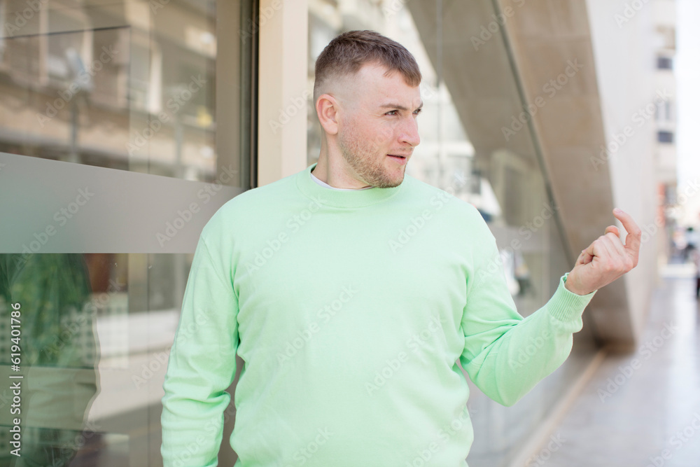handsome man feeling happy, successful and confident, facing a challenge and saying bring it on! or welcoming you handsome man feeling happy, successful and confident, facing a challenge and saying bring it on! or welcoming you