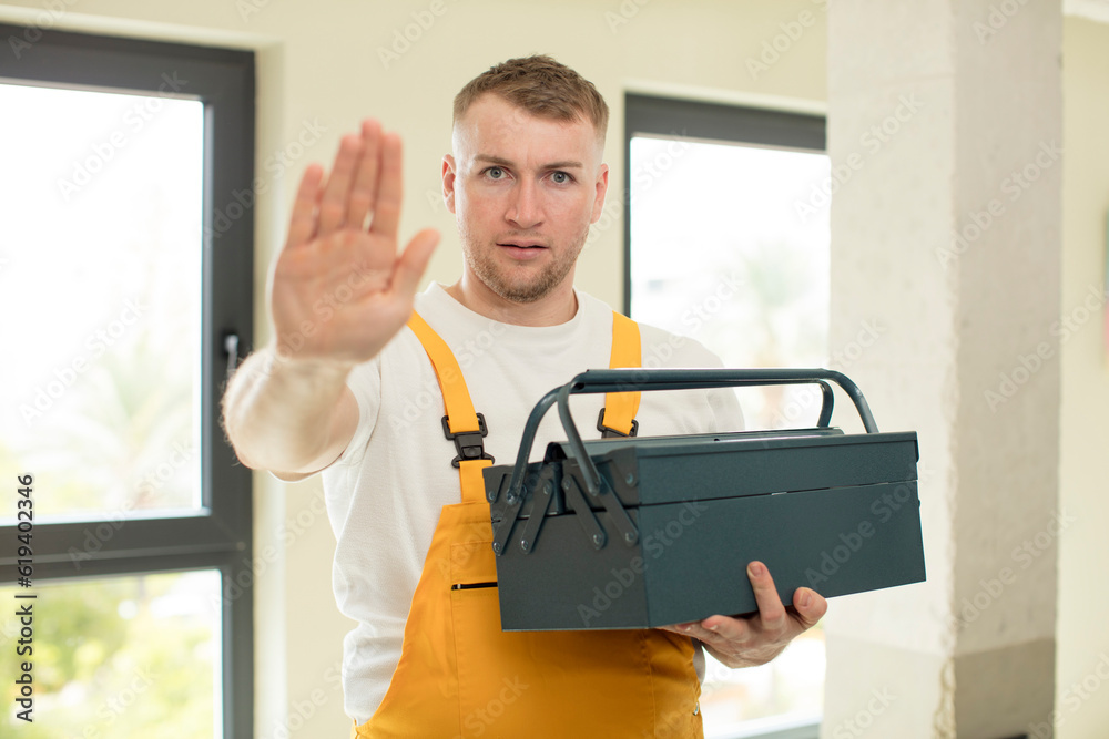 Fototapeta premium looking serious showing open palm making stop gesture. toolbox concept