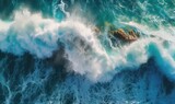  an aerial view of the ocean with a rock in the middle. generative ai
