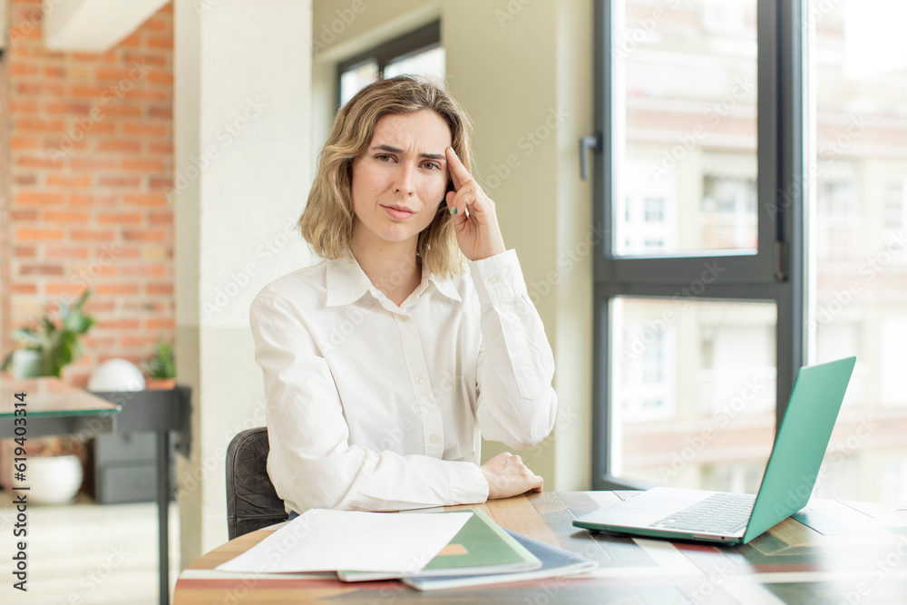 pretty woman looking surprised, realizing a new thought, idea or concept. home work telecommuting concept pretty woman looking surprised, realizing a new thought, idea or concept. home work telecommuting concept