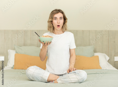 pretty woman feeling extremely shocked and surprised. breakfast bowl