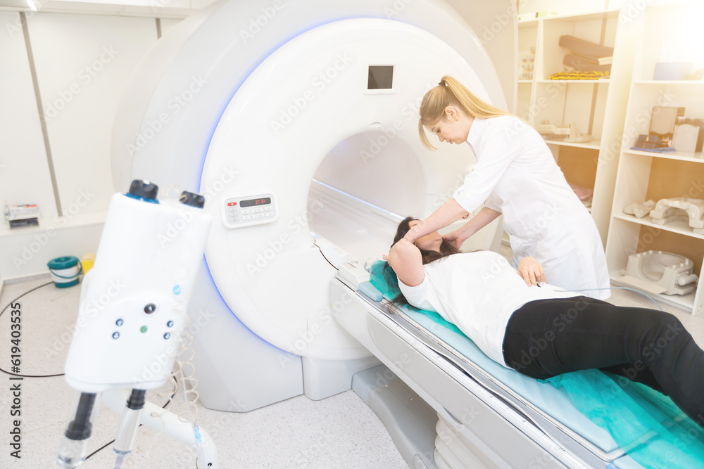 Medical CT or MRI Scan with a patient in the modern hospital laboratory. Interior of radiography department. Technologically advanced equipment in white room. Magnetic resonance diagnostics machine Medical CT or MRI Scan with a patient in the modern hospital laboratory. Interior of radiography department. Technologically advanced equipment in white room. Magnetic resonance diagnostics machine
