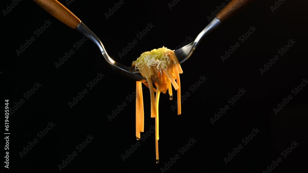 Cooked bigoli pasta twisted on fork with olive oil and parmesan