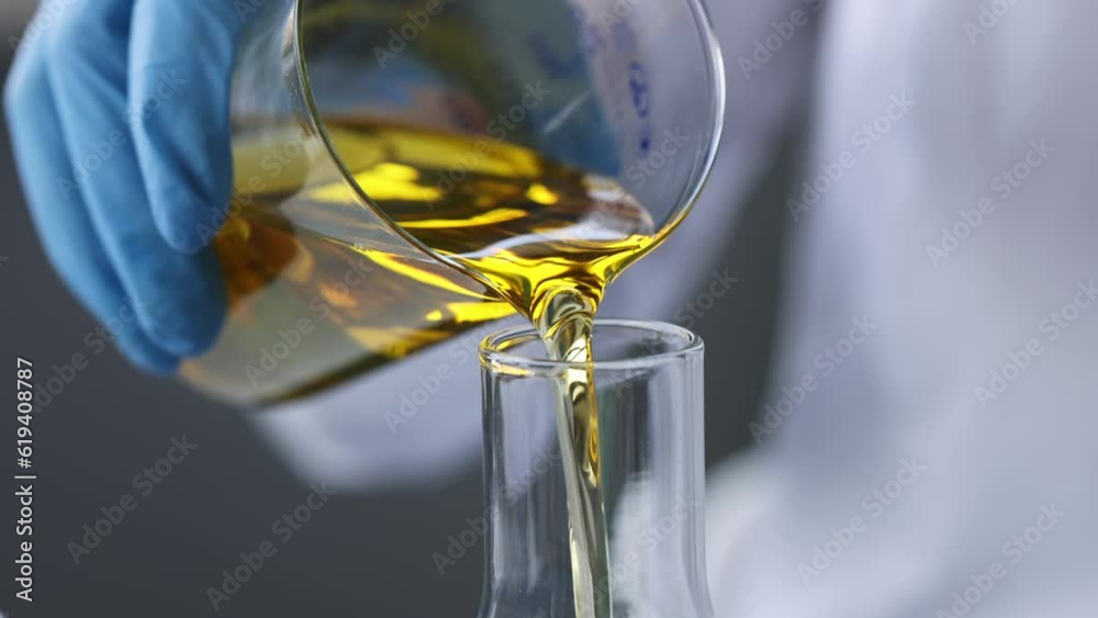 Scientist chemist pouring motor oil into test tube closeup 4k movie. Diesel fuel quality control concept