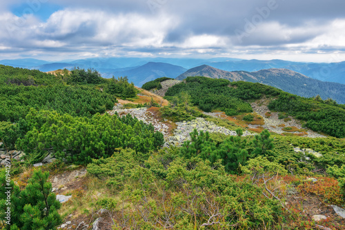 stone covered top of the mountain. beautiful view in to the distant mountain range. landscape of ukrainian carpathians with overcast sky