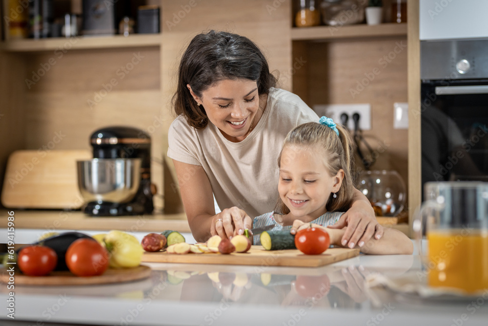 Happy mother and daughter smiling and prepare delicious vegetables Happy mother and daughter smiling and prepare delicious vegetables