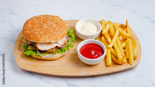 Chicken hamburger and fries on tray
