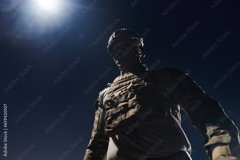 A professional soldier in full military gear striding through the dark night as he embarks on a perilous military mission A professional soldier in full military gear striding through the dark night as he embarks on a perilous military mission