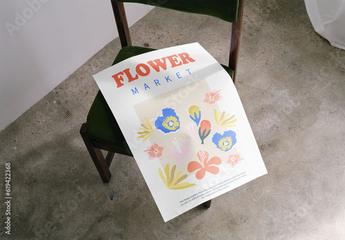 Mockup of customizable A2 poster on chair, high angle