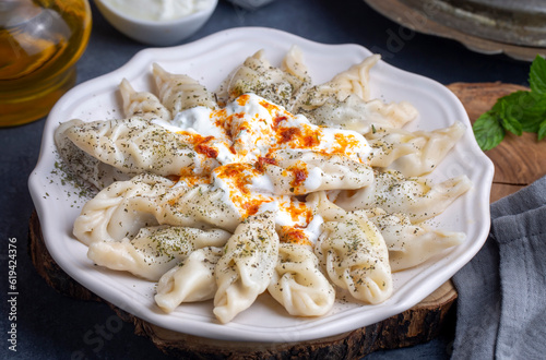 Traditional manti food on plate, top view. The concept of oriental cuisine. Uzbek food manty dumplings. (Turkish name; hinkel mantisi + cecen manti) photo