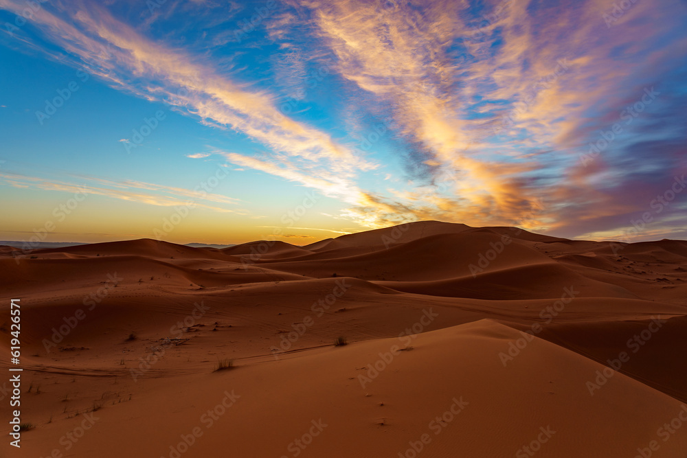 Morocco. Merzouga. Sand dunes of Sahara desert under a blue sky at dusk