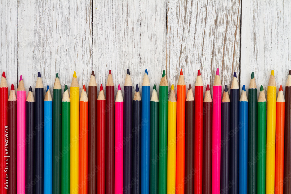 Colored pencil crayons school background on old wood desk Stock Photo