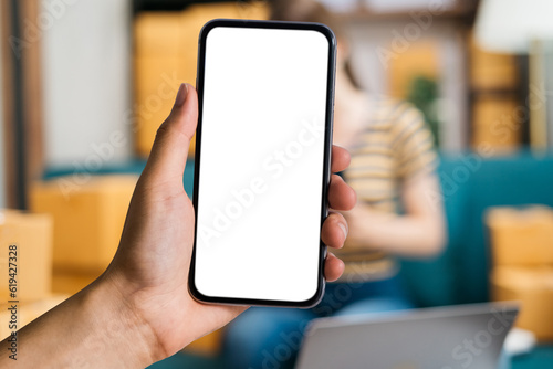 Man holding smartphone with blank screen, close-up of hands. Space for text.