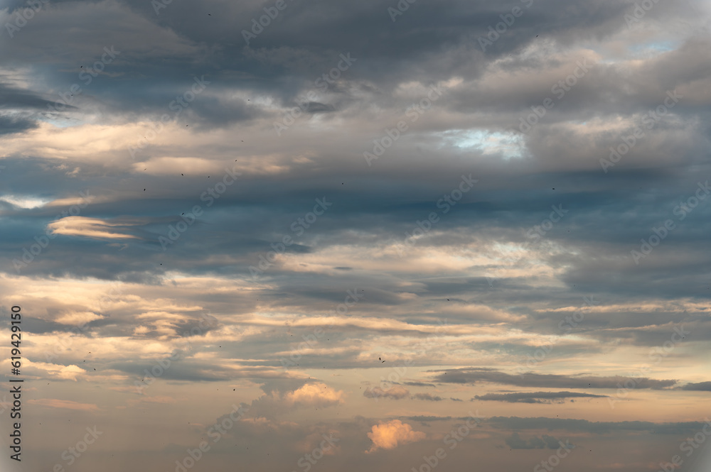 Cumulus clouds and gaps of clear blue sky.