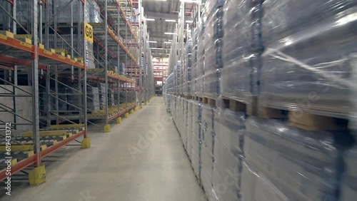 drive through steadicam wide shot of warehouse with shelves full of various packages and goods