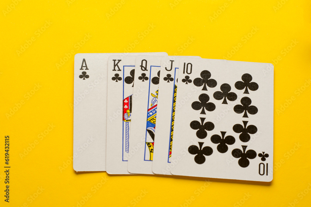 Royal Flush. Five playing cards - the poker royal flush hand on yellow background. Success in gambling. Royal Flush. Five playing cards - the poker royal flush hand on yellow background. Success in gambling.